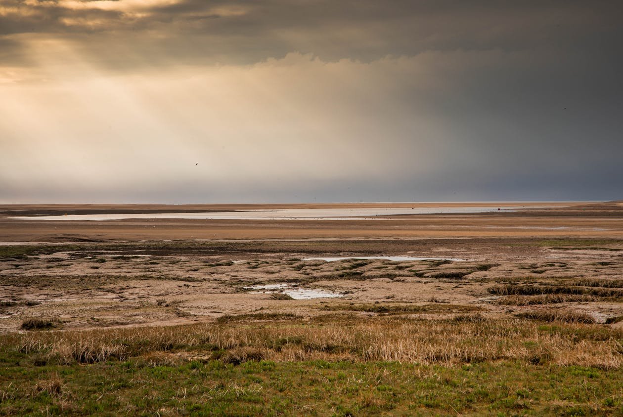 Norfolk beach with sunlight breaking through clouds