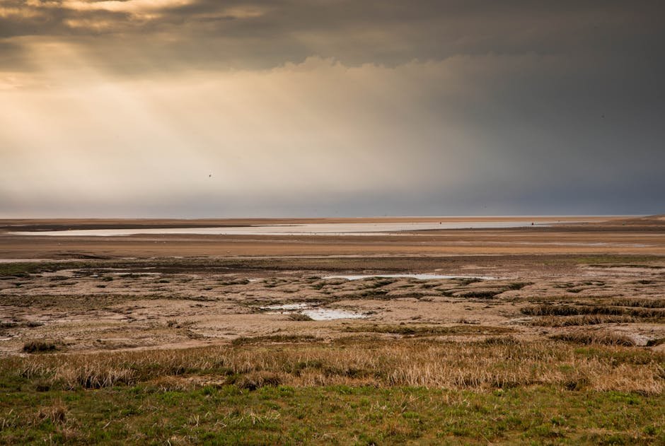 Norfolk coast, England, with sun rays breaking through cloud over the sea