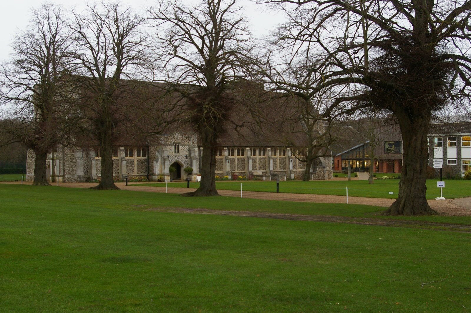The flint chapel of Gresham’s School at Holt seen across the playing field under bare trees